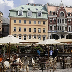 Tourists rest at the open-air cafe in downtown Riga
