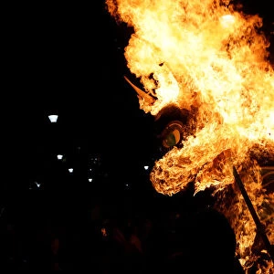 Traditional bull figure known as El Torito burns after exploding with fireworks in