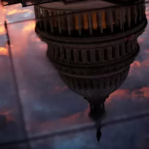 The U. S. Capitol dome is reflected in the glass skylight of the Capitol Visitor Center
