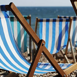 A vendor renting deck chairs dozes in the sun in Brighton, southern England