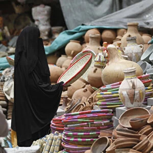 A woman shops at the old market in the historic city of Sanaa