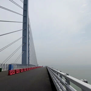 A worker walks on the Hong Kong-Zhuhai-Macau bridge under construction in Zhuhai