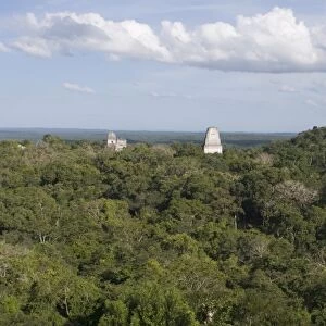Temples rising above the rainforest at Tikal viewed from Temple 1V Guatemala