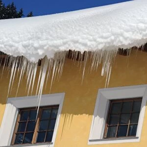 Deep snow and icicles on roof, Davos, Graubunden, Swiss Alps, Switzerland, january