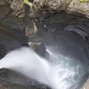 Glacier waterfall flowing over eroded rocks inside mountain, Trummelbach Falls, Lauterbrunnen, Bernese Oberland