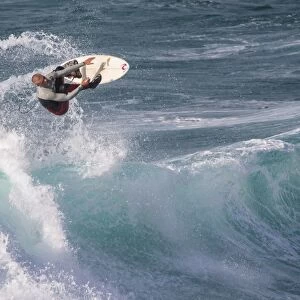 Man surfing on wave, Sennen Cove, Sennen, Cornwall, England, May