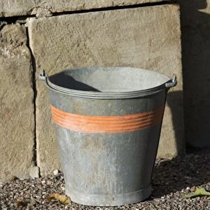 Metal bucket in farmyard, Sweden, october