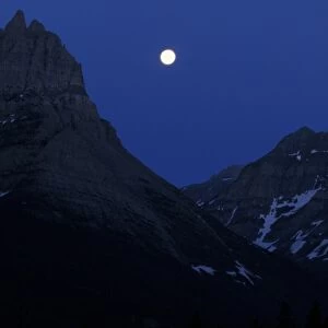 Montana The moon over mountain range, Glacier National Park, Montana, USA