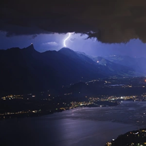 Thunderstorm with lightning and fireworks over city and lake at night, Thun, Lake Thun, Swiss Alps, Bernese Oberland