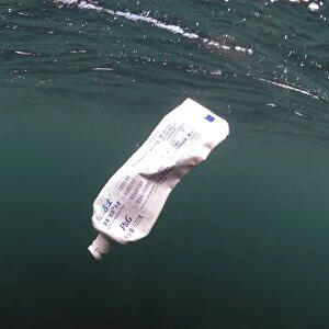 Toothpaste tube floating in sea, Isle of Purbeck, Dorset, England, august