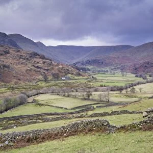 View of drystone walls and pasture in valley surrounded by fells, Kentmere, Lake District N. P