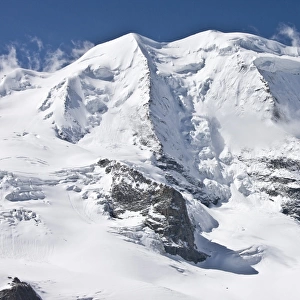 View of snow covered mountain peak at 3905m, Piz Palu, Bernina Group, Upper Engadin Valley, Swiss Alps, Switzerland