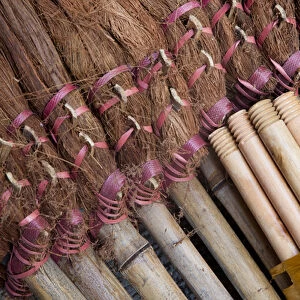 Asia, China, Hong Kong. A display of handmade straw dust brooms for sale