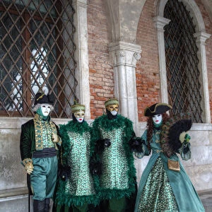 Two Couples all dressed up Venice at Carnival Time, Italy