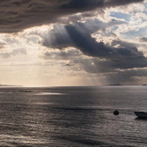 Dramatic light over a little boat, Mamanucas islands, Fiji, South Pacific