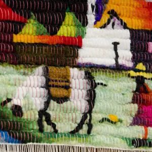 Ecuador, Quito area, Otavalo Handicraft Market. Detail of traditional wool souvenir rug