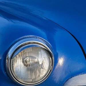 Detail of front end headlight on a classic blue American car in Vieja, old Habana, Havana
