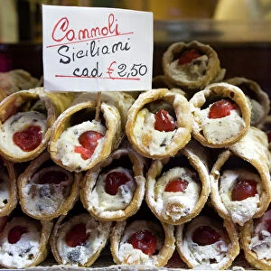 Europe, Italy, Venice. Cannoli for sale seen through a bakery window