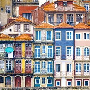 Europe, Portugal, Porto. Colorful building facades next to Douro River. Credit as