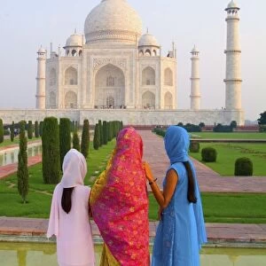 Hindu women with colorful veils in the quiet peaceful Taj Mahal one of the wonders