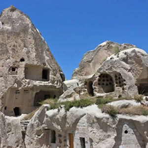 Houses carved into rock formation, Goreme, Cappadocia, Turkey