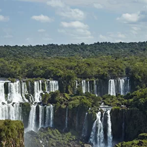 Iguazu Falls on Argentina side and tourist boat on Iguazu River, Brazil and Argentina