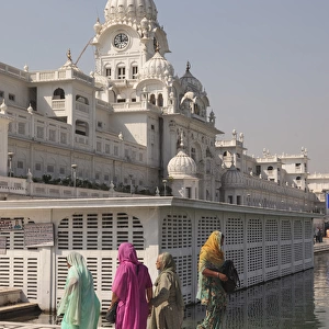 India, Punjab, Amritsar. Pilgrims walking at Golden Temple