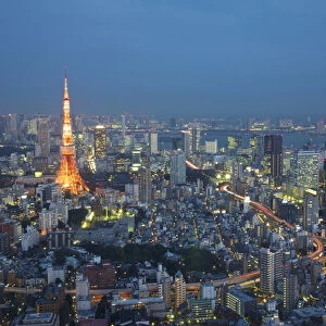 Japan, Tokyo. Sunset aerial of downtown including Tokyo Tower and Rainbow Bridge