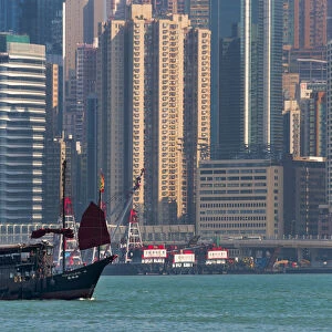 Junk boat and high-rise in Victoria Bay, Hong Kong, China