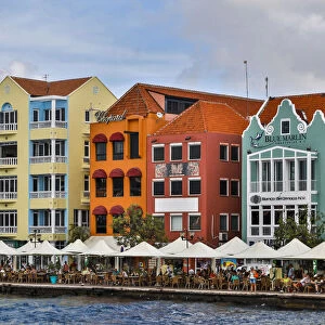 Lesser Antilles, Curacao, Willemstad. People relaxing along the waterfront at the