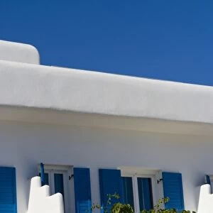 A local whitewashed building with beautiful flowers, Mykonos, Greece
