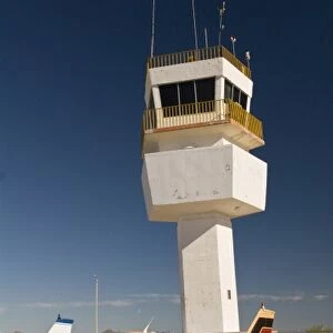 Mexico, Baja California, San Felipe. Control tower and single engine planes at airstip