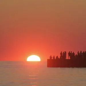 People lighthouse sunset silhouette at South Haven Michigan