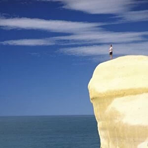 Person on cliff top, Tunnel Beach, Dunedin, New Zealand