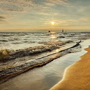 Shoreline of Lake Michigan and distant Grand Haven Lighthouse and pier, Grand Haven