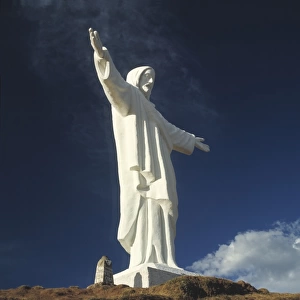 South America, Peru, Cuzco. A dramatic view of the statue of Christ that stands above Cuzco, Peru