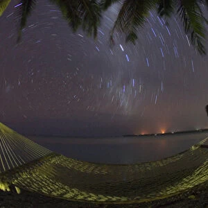 South Pacific, Cook Islands, Aitutaki. Stars rotate around the South Pole above a