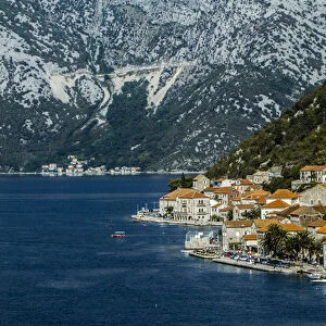 Tivat, Eastern Fjords, Montenegro. Orange tiled roofs, church and a village waterfront