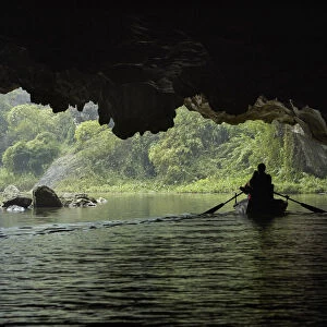 Tourists in cave on Tam Coc (three caves) boat trip on Ngo Dong River, (UNESCO World