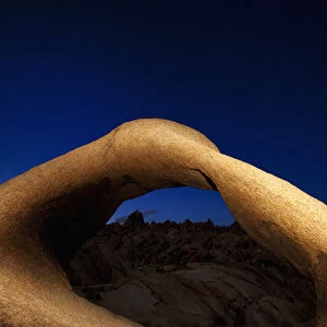 USA, California, Sierra Nevada Mountains. Mobius Arch illuminated in the Alabama Hills