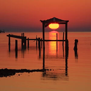USA; Florida; Apalachicola; Old boat house at sunrise on Apalachicola Bay