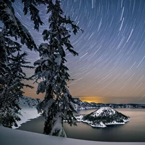 USA, Oregon, Crater Lake National Park. Star trails over Crater Lake and Wizard Island in winter