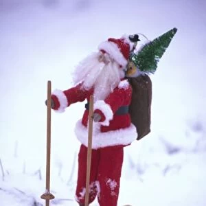 USA, Washington, Bellingham. Toy Santa Claus on skis and snow. Credit as: Steve Satushek