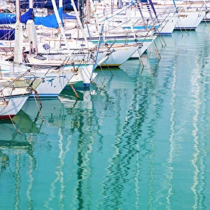 White sailboats in blue water