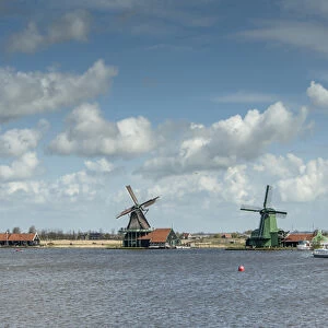 WIndmills along a lake in a peaceful country scene
