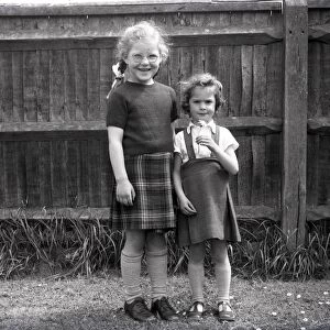Two girls in playground of Lancastrian Infants School, Chichester, May 1956