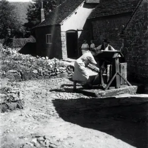 Two people using a well on a farm at Upperton, Sussex, August 1936