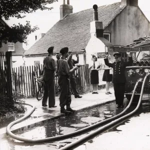 Soldier pointing pistol at fire service personnel