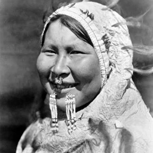 ALASKA: ESKIMO WOMAN. An Eskimo woman wearing a nose ring and and a labret, dressed