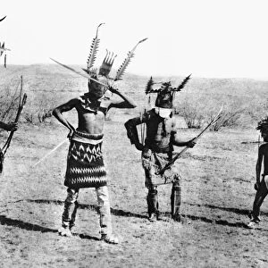 APACHE DANCE, 1889. Four costumed Apache men performing a mountain spirit dance, a ritual in which a clown (second from right) also participates. Photographed in 1889 by Katherine T. Dodge